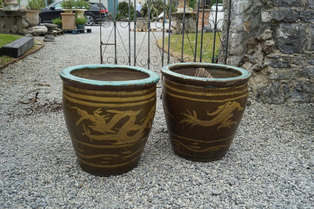 PAIR OF CHINESE GLAZED TERRACOTTA JARDINIERES: each of ovoid from with dragon scroll decoration. 43 cm. high; 44 cm. wide; Approximate Time: 12:11 Lot No: 547 Category: Garden & Decorative Objects