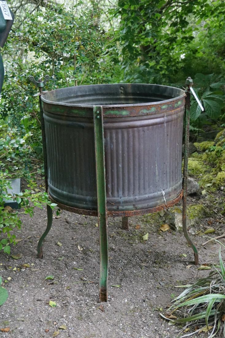 DOLLY TUB: raised on scroll legs. 74 cm. high; 56 cm. in diameter; Approximate Time: 12:16 Lot No: 553 Category: Garden & Decorative Objects
