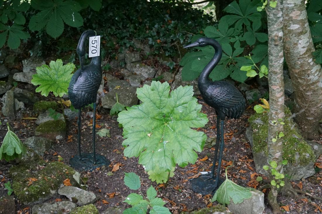 PAIR OF CAST IRON GARDEN SCULPTURES: each a crane standing on a rocky mound. 72 cm. high; Approximate Time: 12:32 Lot No: 570 Category: Garden & Decorative Objects