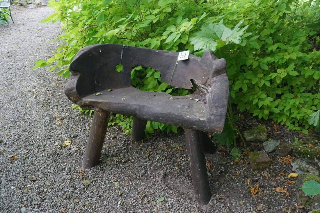 CARVED DUG OUT GARDEN BENCH: raised on splayed legs. 63 cm. high; 85 cm. wide; Approximate Time: 12:33 Lot No: 572 Category: Garden & Decorative Objects