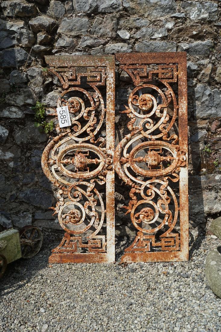 PAIR OF CAST IRON DECORATIVE PANELS: each with urn and scroll decoration. 38 cm. high; 105 cm. wide Approximate Time: 12:45 Lot No: 585 Category: Garden & Decorative Objects