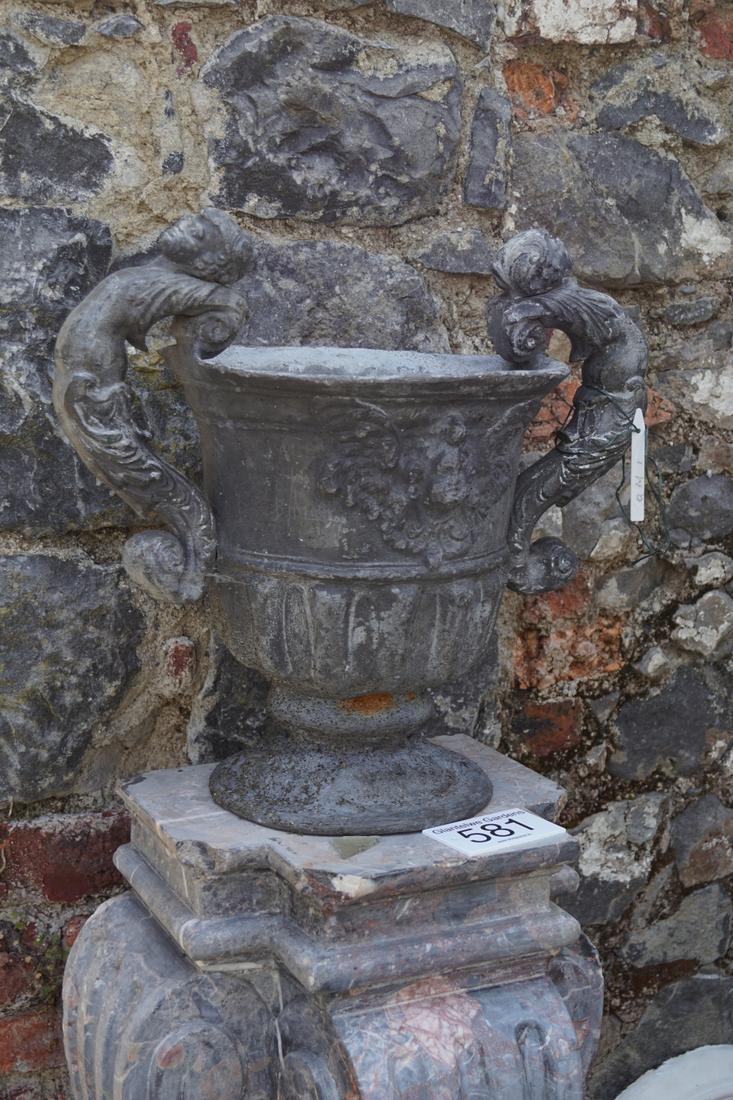 PAIR 18TH-CENTURY LEAD URNS: each of vase shape with cherub mounted scroll handles, raised on ornate circular foot. 50 cm. high; 56 cm. wide; Approximate Time: 14:00 Lot No: 602 Category: Garden & Decorative Objects