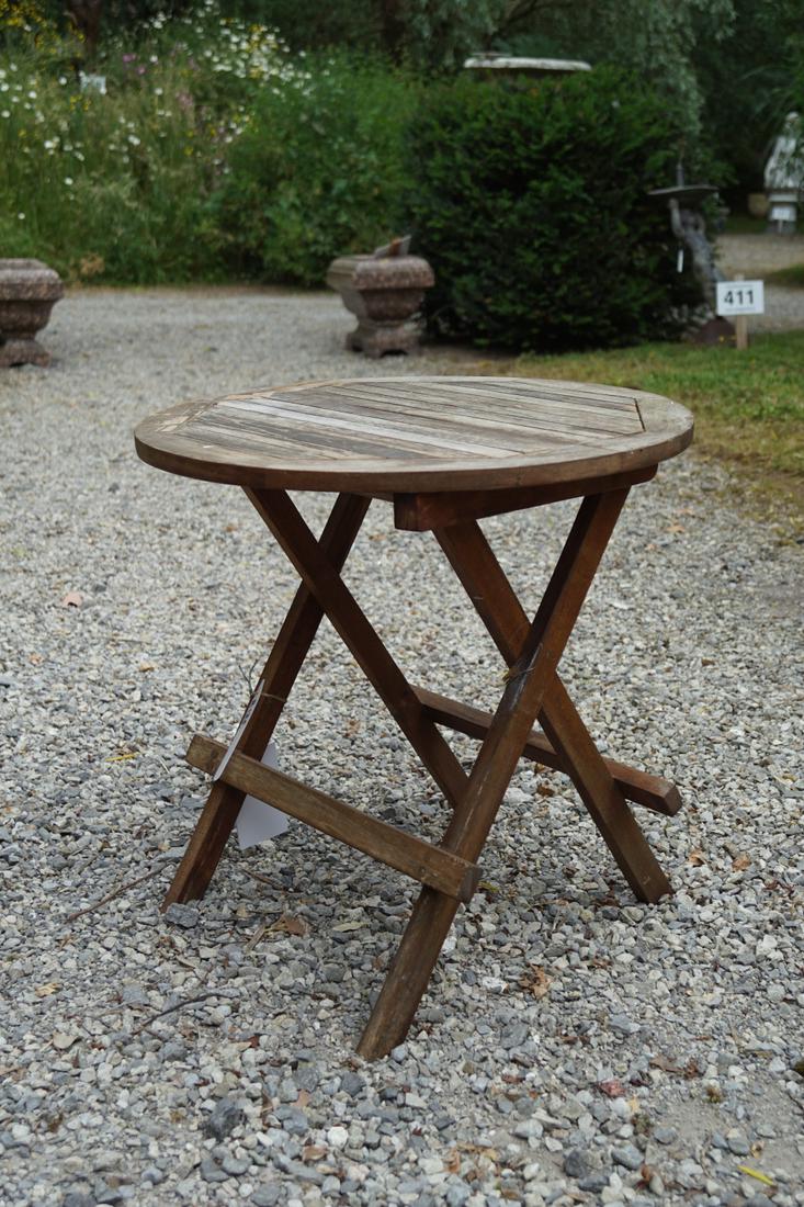 TEAK PATIO FOLDING TABLE: of circular form, supported on an X-frame base. 52 cm. high; 50 cm. diameter Approximate Time: 14:30 Lot No: 635 Category: Garden & Decorative Objects