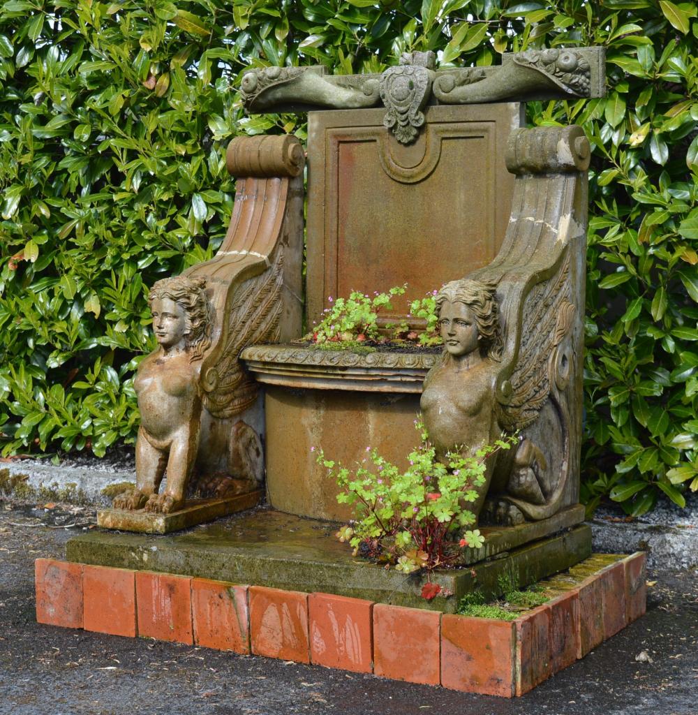 LARGE GARDEN SEAT: raised on sphinx scroll ends. 120 cm. high; 103 cm. wide; 80 cm. deep Approximate Time: 15:11 Lot No: 680 Category: Garden & Decorative Objects