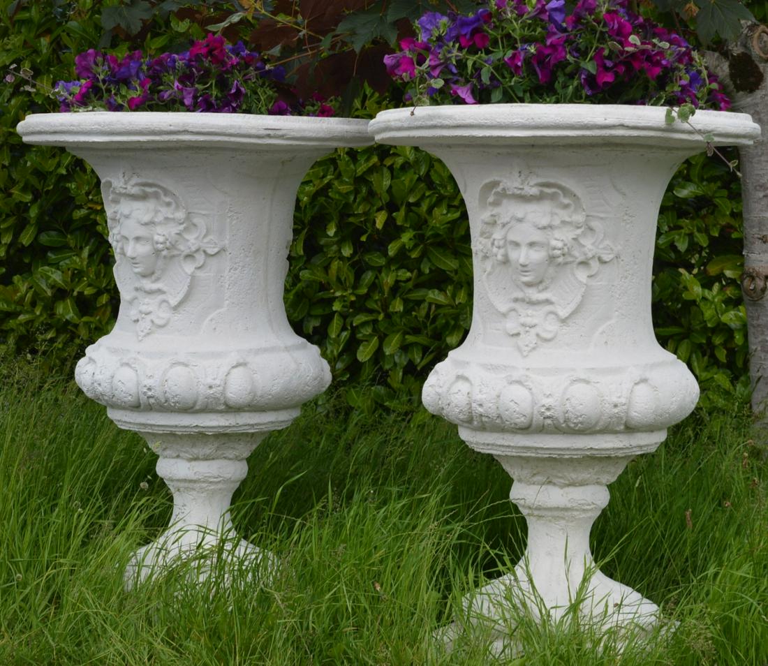 PAIR OF LARGE MOULDED STONE ESTATE URNS: each with mask decoration. 131 cm. high; 92 cm. wide Approximate Time: 15:20 Lot No: 690 Category: Garden & Decorative Objects