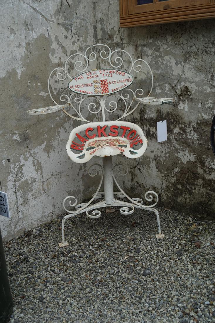 NOVEL WROUGHT IRON GARDEN SEAT: raised on scroll supports. Approximate Time: 15:30 Lot No: 702 Category: Garden & Decorative Objects