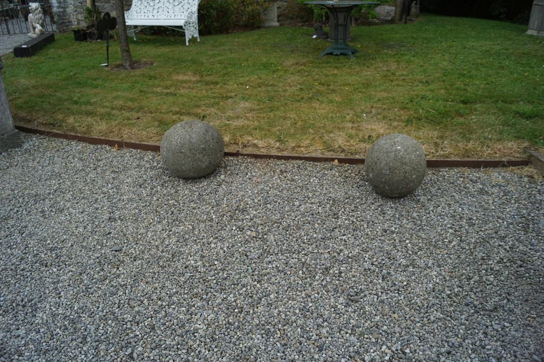 TWO WEATHERED MOULDED STONE SPHERES: Two weathered moulded stone spheres. 45.4 cm. in diameter; Approximate Time: 16:06 Lot No: 742 Category: Garden & Decorative Objects