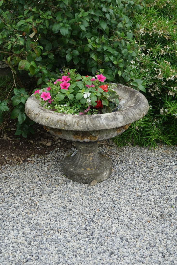 PAIR OF LARGE NEO-CLASSICAL URNS: each raised on a circular fluted base. 55 cm. high; 82 cm. wide Approximate Time: 16:27 Lot No: 765 Category: Garden & Decorative Objects