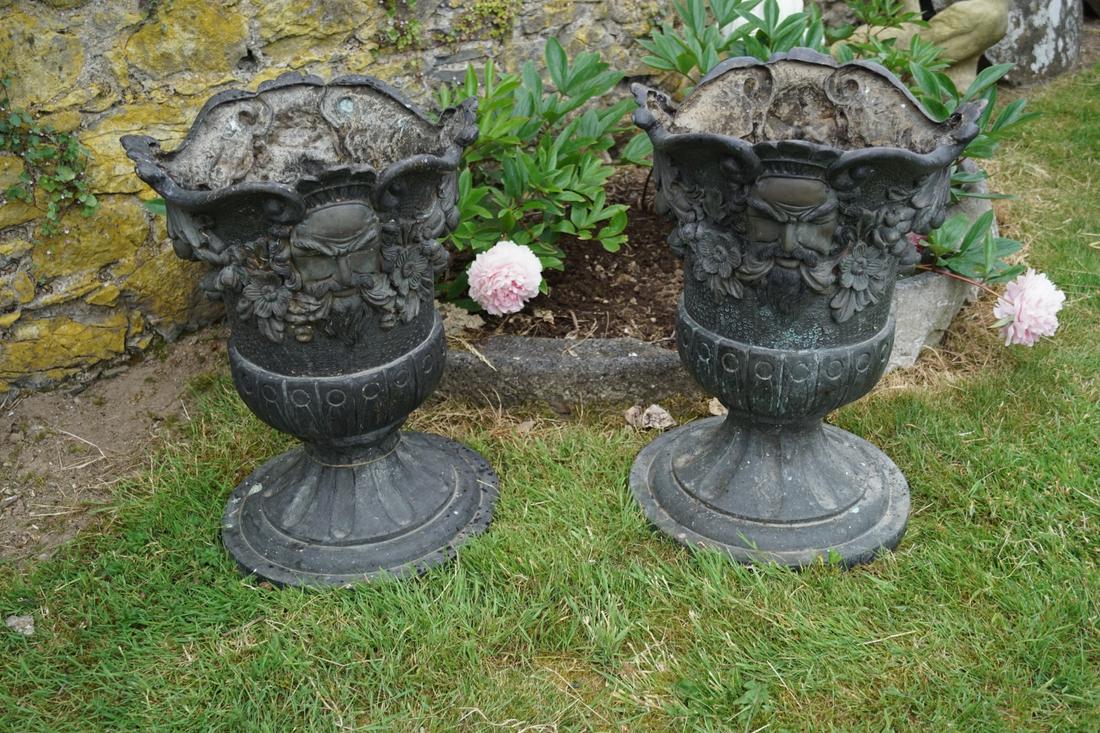 PAIR OF LARGE BAROQUE STYLE BRONZE URNS: each of flower head form with repousse mask and floral swag decoration, raised on a fluted stem and circular base. Approximate Time: 16:30 Lot No: 768 Category: Garden & Decorative Objects