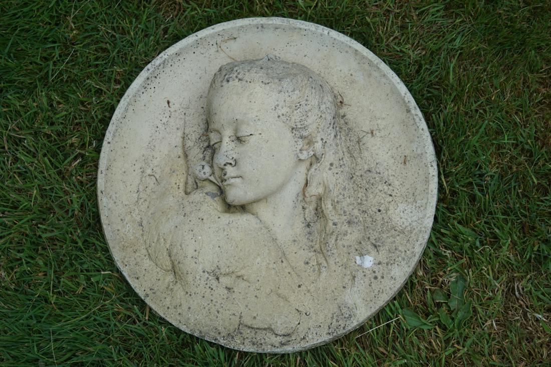 COMPOSITE CIRCULAR GARDEN PLAQUE: depicting the head of a young girl and a bird. 45 cm. high; Approximate Time: 16:38 Lot No: 777 Category: Garden & Decorative Objects