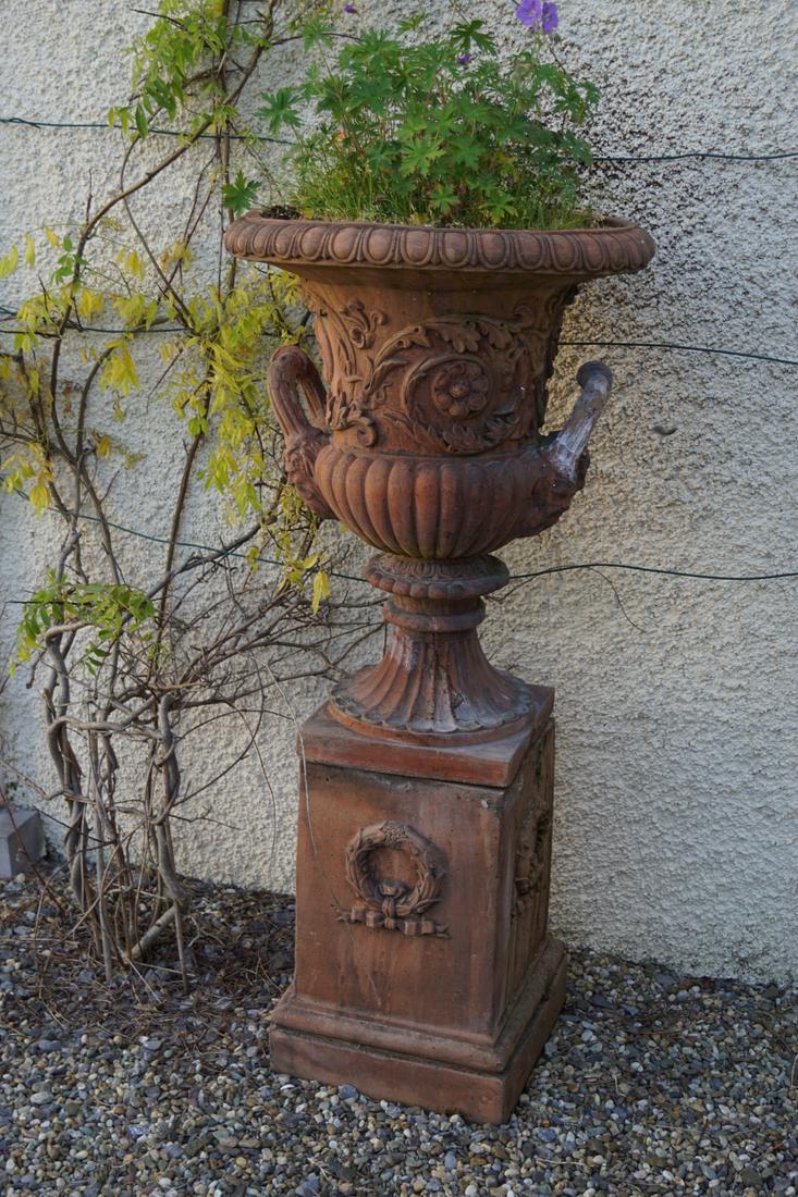 PAIR OF NEO-CLASSICAL TERRACOTTA URNS: with rich moulded decoration, each raised on a square plinth. 127 cm. high; 65 cm. in diameter; Approximate Time: 16:43 Lot No: 783 Category: Garden & Decorative Objects