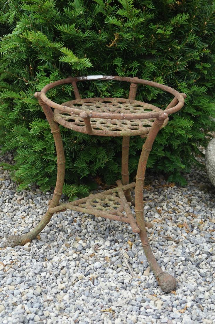 CAST IRON PLANT STAND: the openwork circular top, raised on scroll faux bamboo legs joined by an undershelf. 46 cm. high; 46 cm. in diameter; Approximate Time: 16:51 Lot No: 791 Category: Garden & Decorative Objects