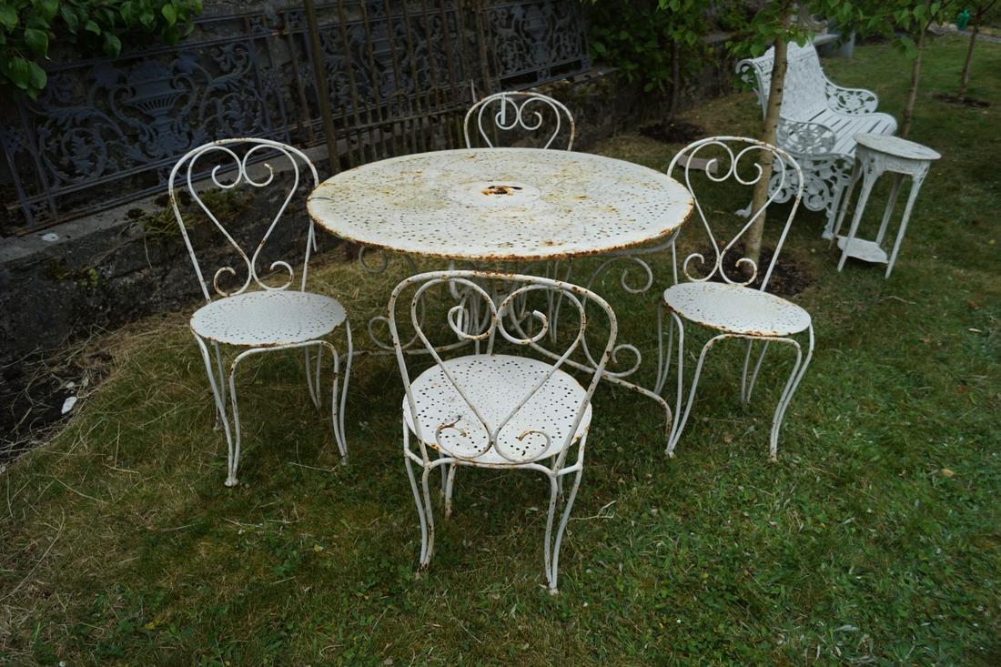 19TH-CENTURY FRENCH GARDEN DINING TABLE: and four chairs. Comprising a circular table and four c-scroll backed chairs. 96 cm. in diameter; Approximate Time: 17:02 Lot No: 804 Category: Garden & Decorative Objects