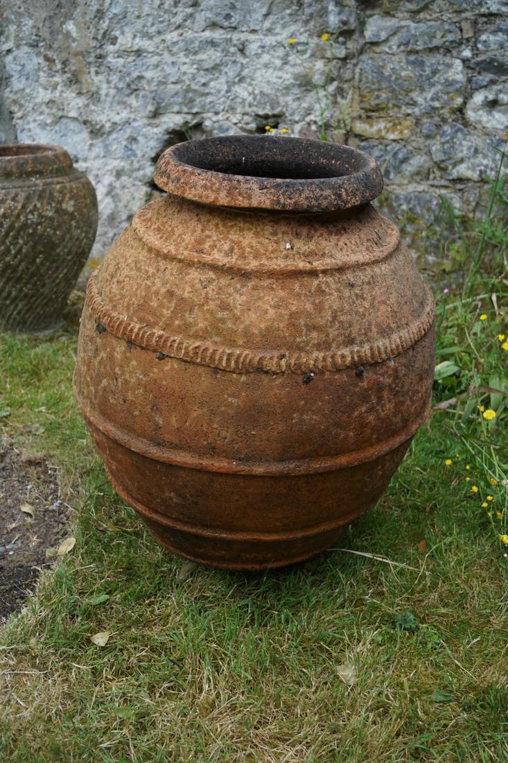 RIBBED TERRACOTTA OLIVE JAR OR PITHOS: of ovoid form, with ribbed decoration. 80 cm. high; 60 cm. wide Approximate Time: 17:18 Lot No: 822 Category: Garden & Decorative Objects
