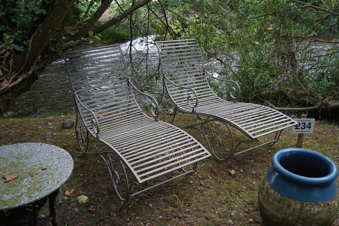 DESIGNER METAL RECLINING CHAIR: with scroll arms, raised on flowing scroll supports. 100 cm. high; 150 cm. wide; 60 cm. deep Approximate Time: 17:45 Lot No: 856 Category: Garden & Decorative Objects