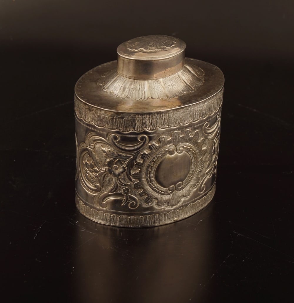 DUBLIN SILVER TEA CADDY: of oval shape with rich chased and repousse leaf and floral decoration. Dublin 1771. Provenance: The Dr. Kevin Moynihan Collection, Macroom, Co. Cork. 11 cm. high; 11 cm. wide; 8 cm. deep; Approximate