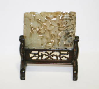 Ming period celadon jade panel: Ming period celadon jade panel with russet inclusions, depicting figures and birds in a garden