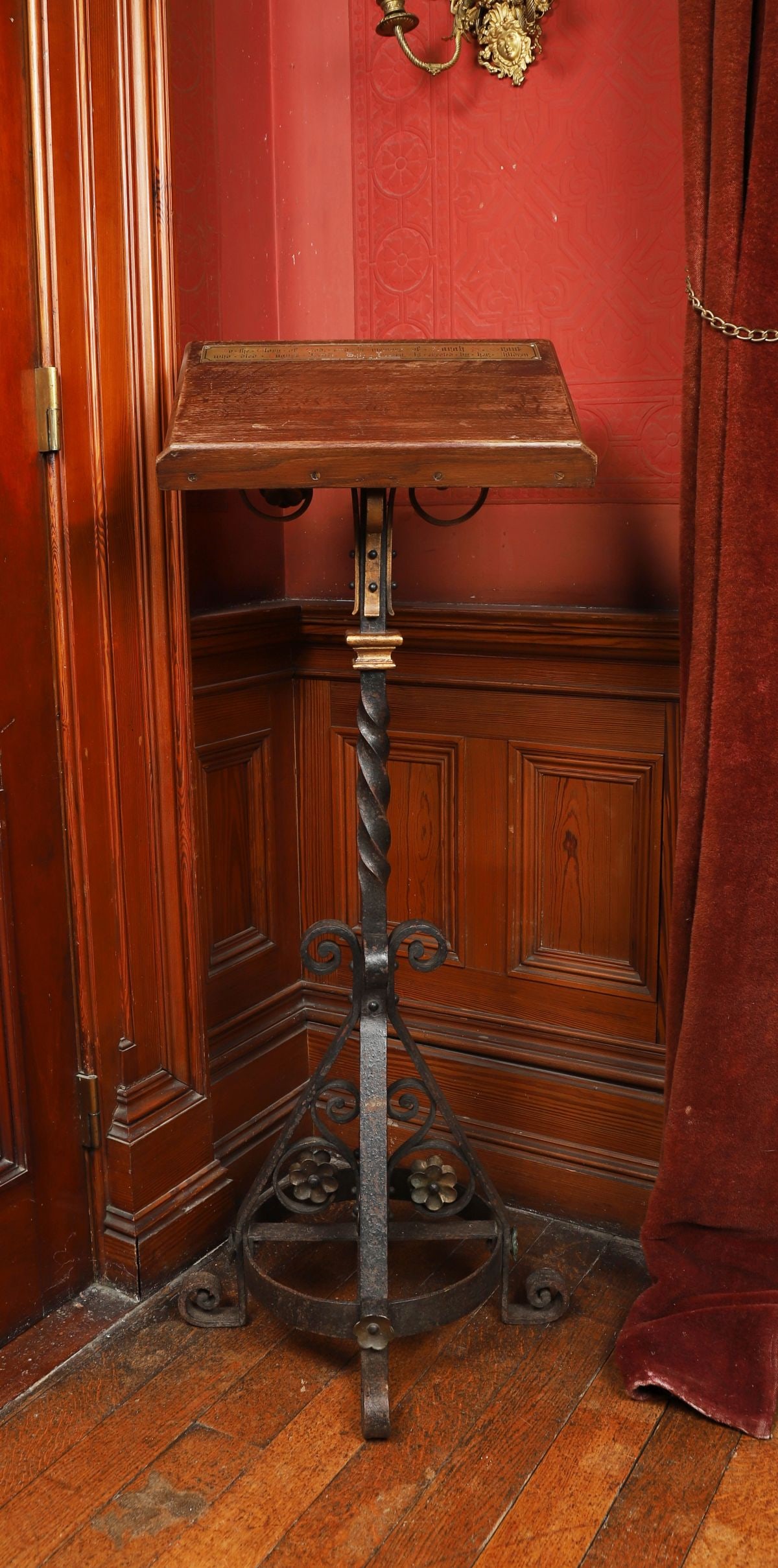 19TH-CENTURY OAK AND WROUGHT IRON LECTERN: A 19th-century lectern with rectangular oak reading slope, raised on a wrought iron spiral-twist column and scrolling tripod base, the ironwork of ecclesiastical character. FURNITURE
