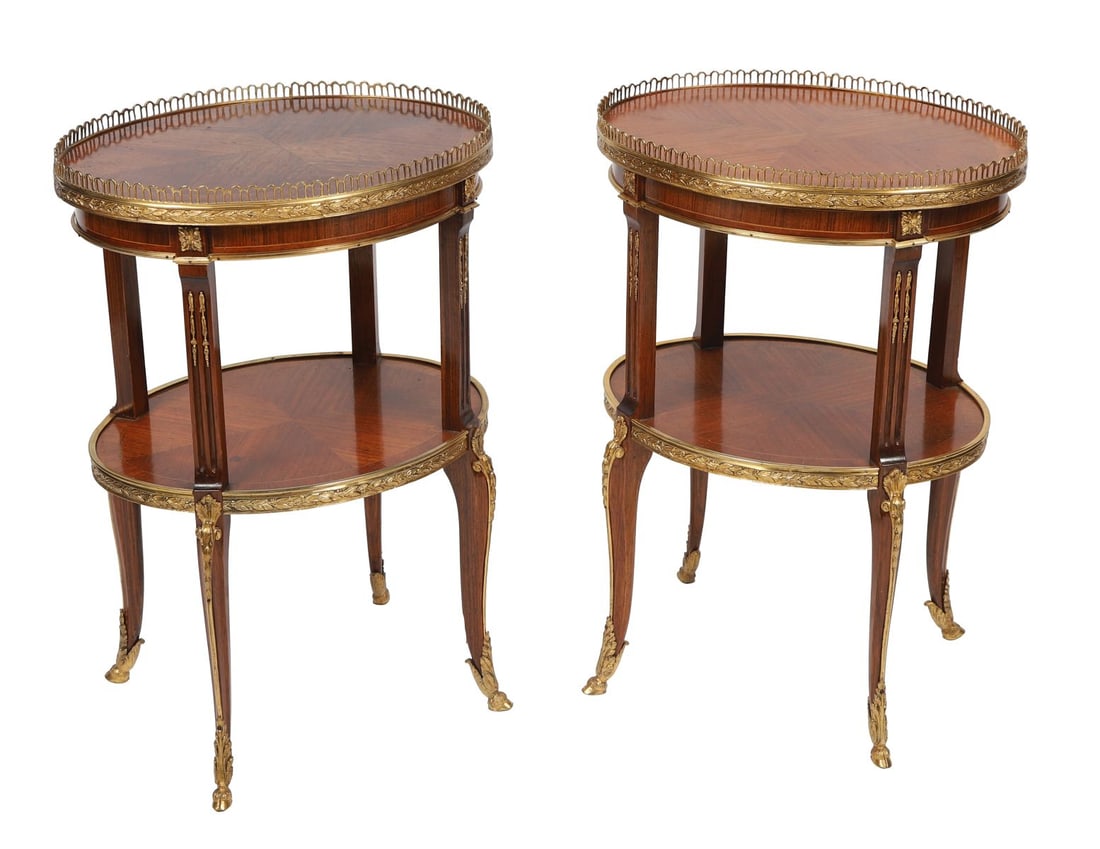 PAIR FRENCH MAHOGANY TWO-TIER OCCASIONAL TABLES: 19TH-CENTURY, ORMOLU-MOUNTED, each with a circular top with pierced gallery, raised on slender supports to a lower tier, with applied ormolu mounts and sabre legs. FURNITURE