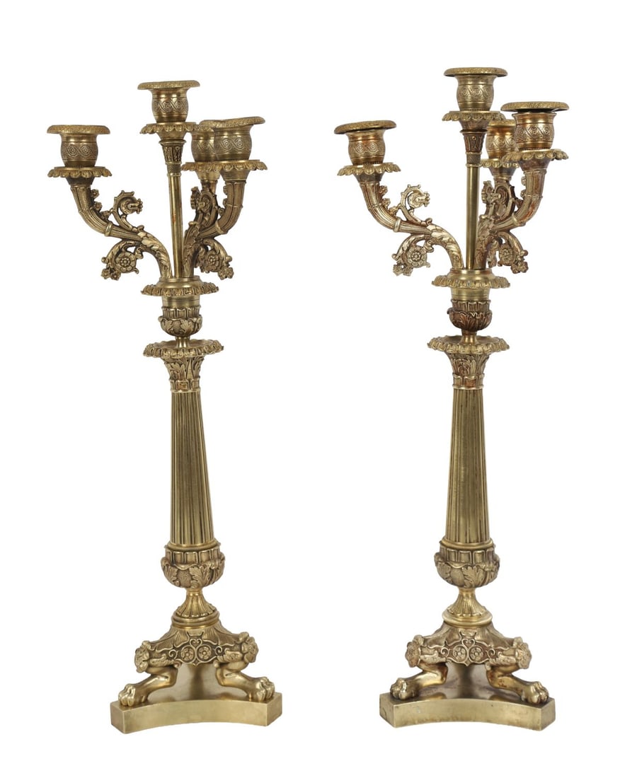 PAIR 19TH-CENTURY GILT-BRONZE CANDELABRA: Pair of gilt-bronze candelabra, each with a fluted column supporting scrolling arms with cast foliate decoration and shaped sconces, raised on shaped bases with paw feet. LIGHTING