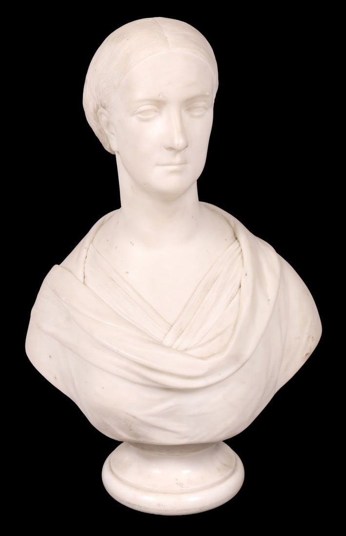 STATUARY WHITE MARBLE BUST: A statuary white marble bust of a classical female figure, her hair drawn back and drapery finely carved, raised on a circular socle. SCULPTURE