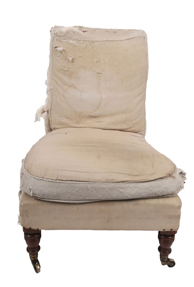 19TH-CENTURY HOWARD & SONS ARMCHAIR: Upholstered armchair of typical Howard form, raised on turned legs with castors, retaining later upholstery, the frame of good quality with shaped arms and back. FURNITURE