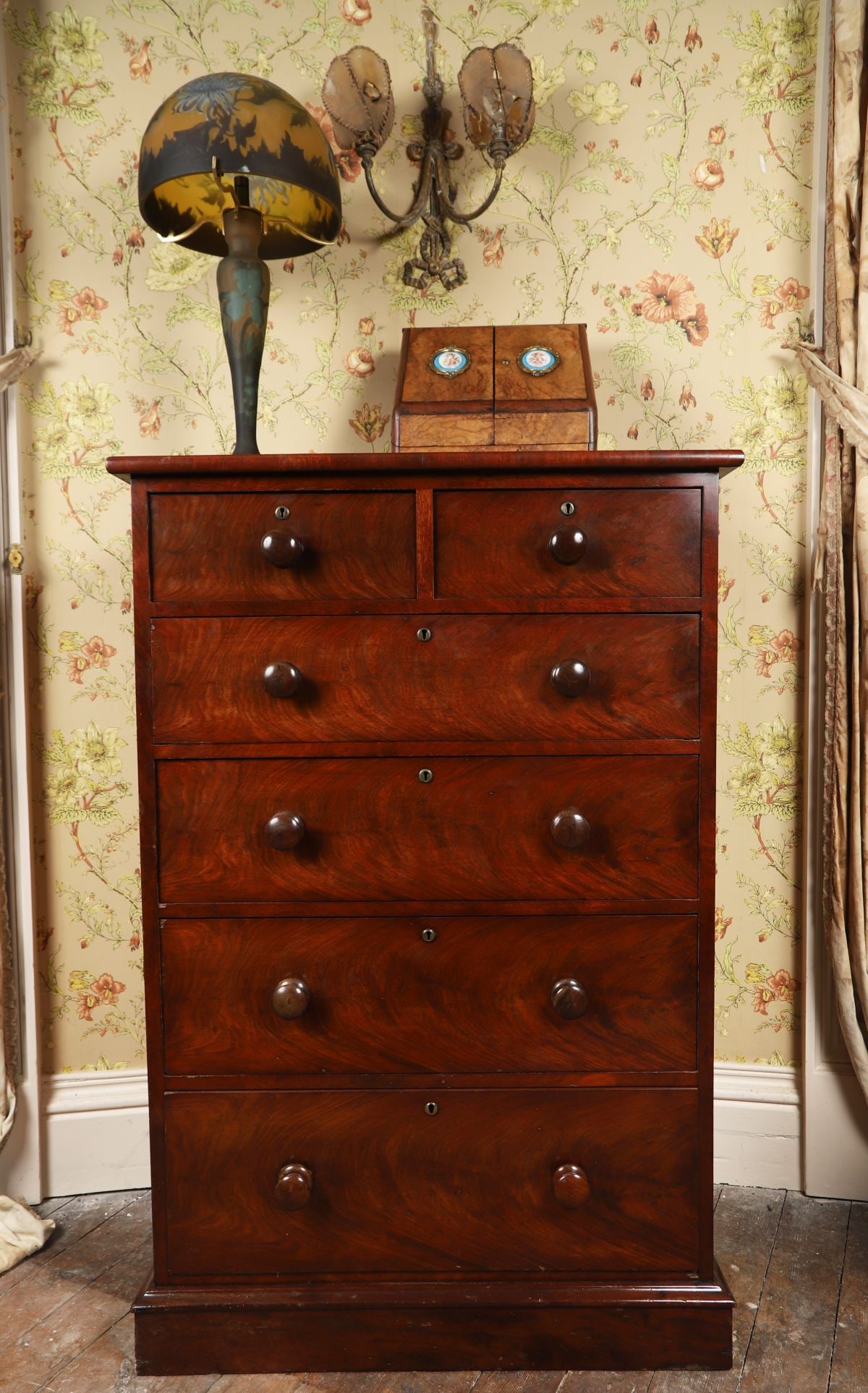 GEORGE III DUBLIN MAHOGANY TALL CHEST OF DRAWERS: The rectangular top above two short and four long graduated drawers, fitted with turned wooden knobs, raised on a plinth base, the fronts with well-figured mahogany veneers. FURNITURE