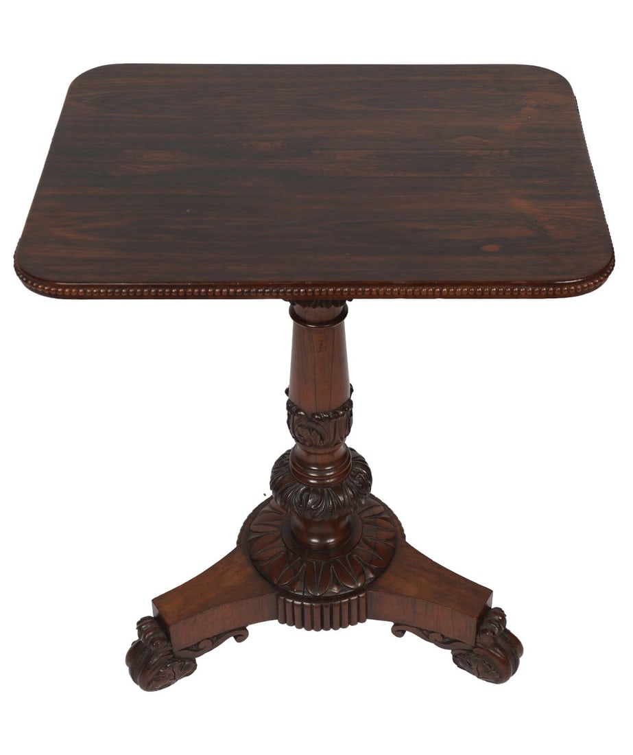 WILLIAM IV ROSEWOOD OCCASIONAL TABLE: A William IV rosewood occasional table, the rectangular top with moulded edge, raised on a turned and carved pedestal with triform base and scroll feet. FURNITURE