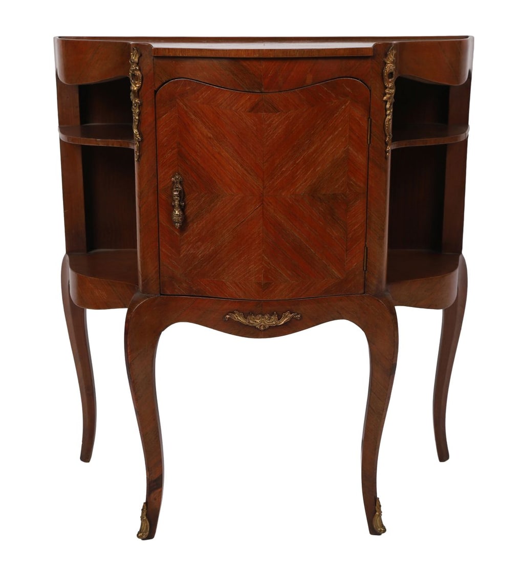 FRENCH KINGWOOD SERPENTINE COMMODE: EARLY 20TH - CENTURY, The serpentine- shaped top above a single cupboard door with parquetry decoration, flanked by open shelves and raised on cabriole legs with gilt-metal mounts. FURNITURE