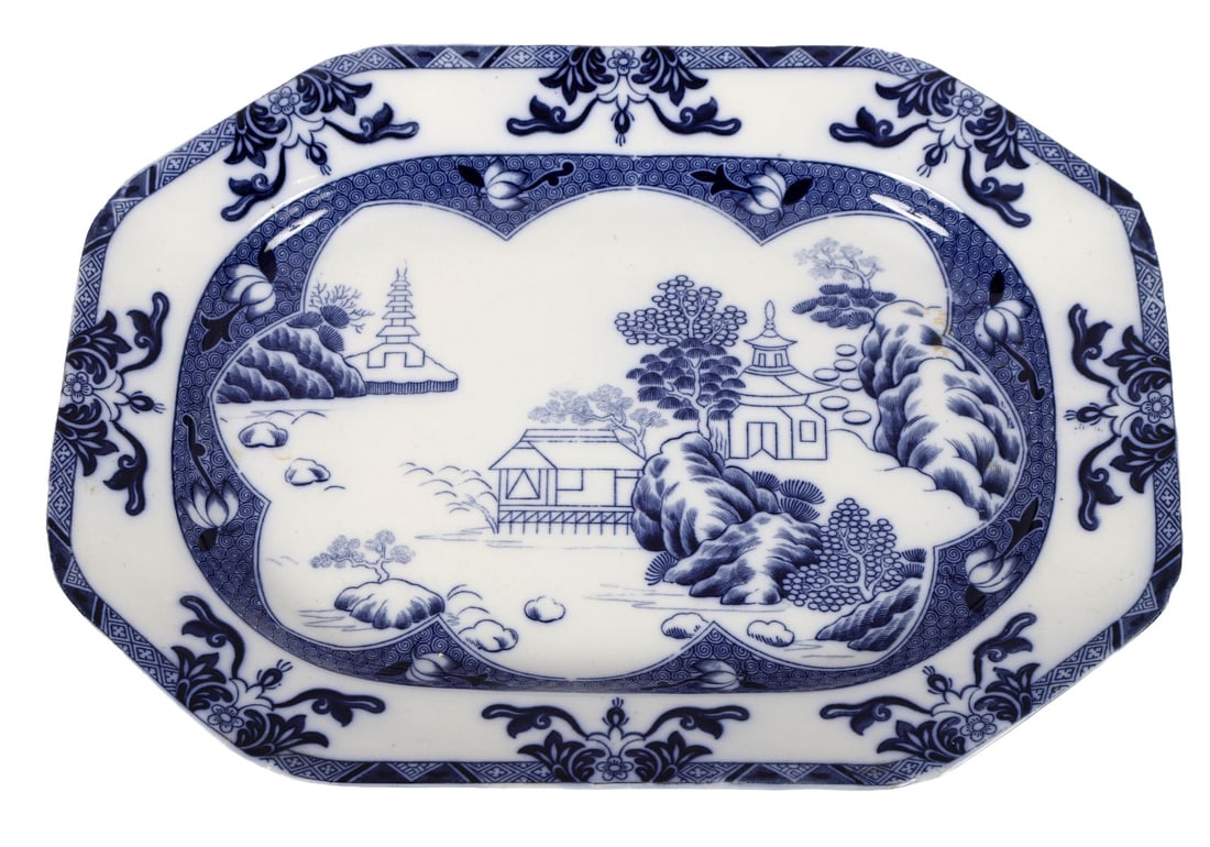 LARGE SPODE BLUE AND WHITE SERVING DISH: Large transfer-printed serving dish of shaped rectangular form, decorated in underglaze blue with a chinoiserie landscape of pagodas, bridges and river scenes within a foliate and geometric border. PO