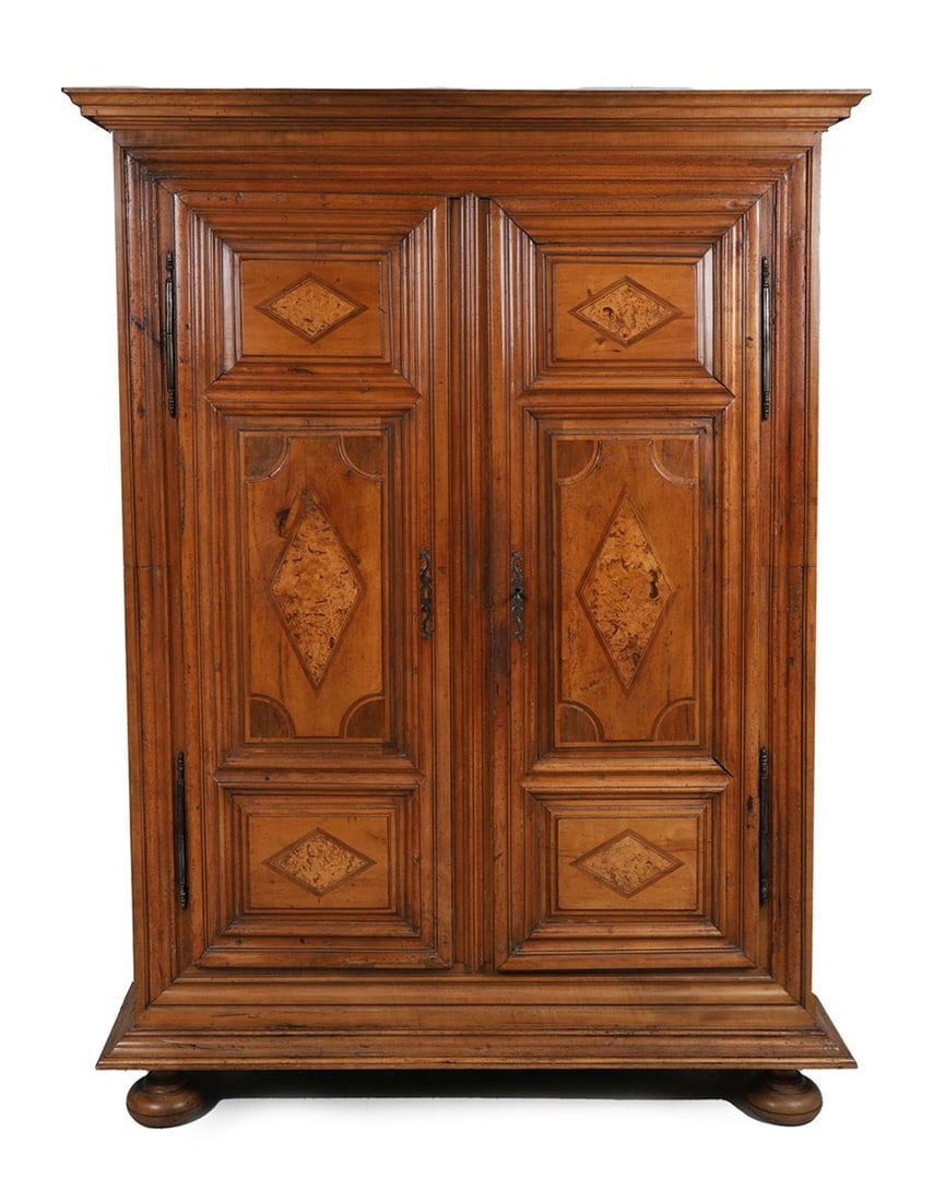 FRENCH FRUITWOOD AND BURR PANELLED ARMOIRE: LATE 18TH - CENTURY, A French provincial fruitwood armoire with moulded cornice above a pair of panelled doors inset with burr panels and geometric diamond motifs, raised on a plinth base, the sides w