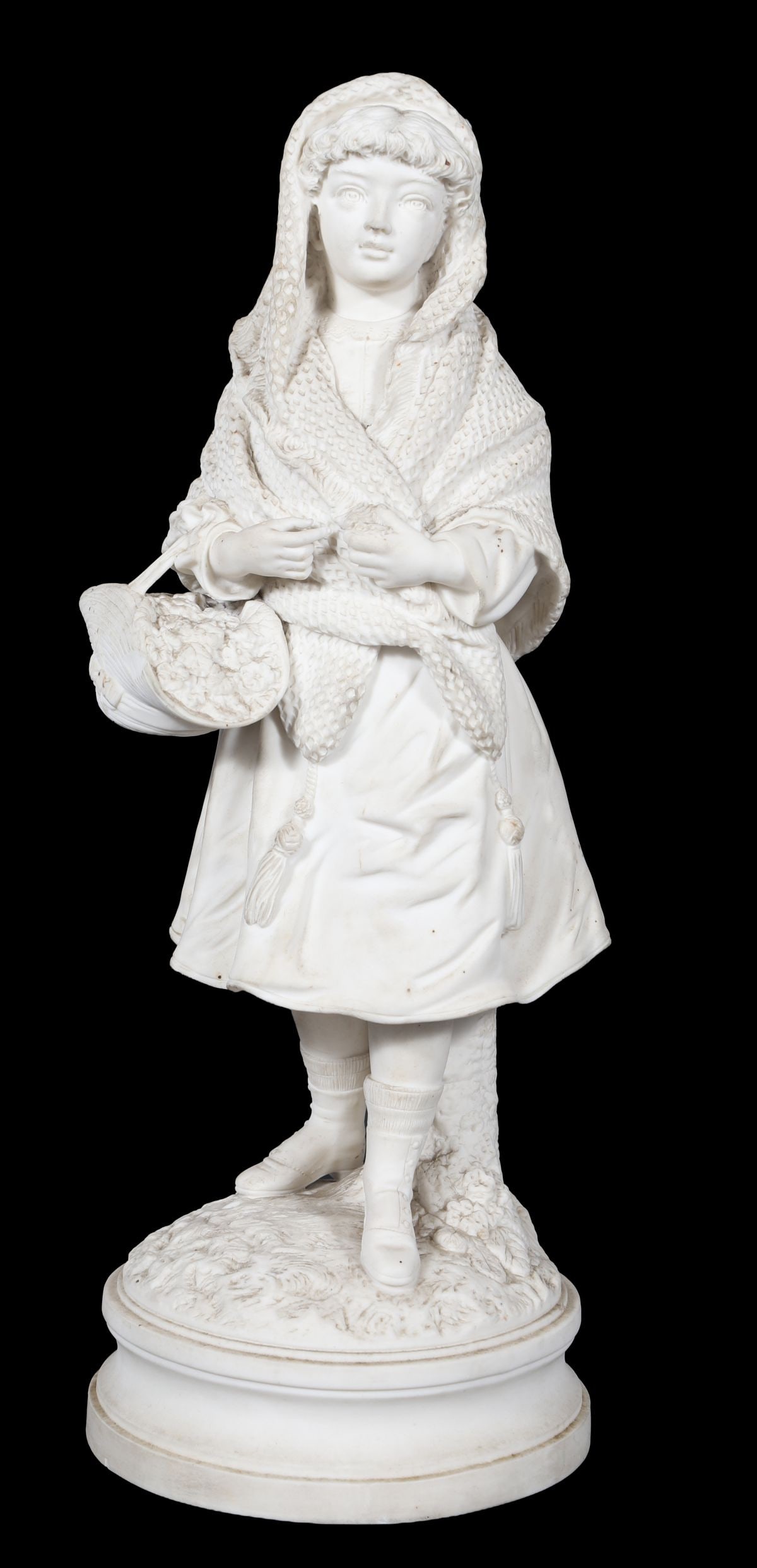 A 19TH-CENTURY PARIAN FIGURE OF A FLOWER GIRL: A 19th-century Parian porcelain figure modelled as a young flower girl holding a basket, wearing a shawl and standing on a naturalistic base. PORCELAIN
