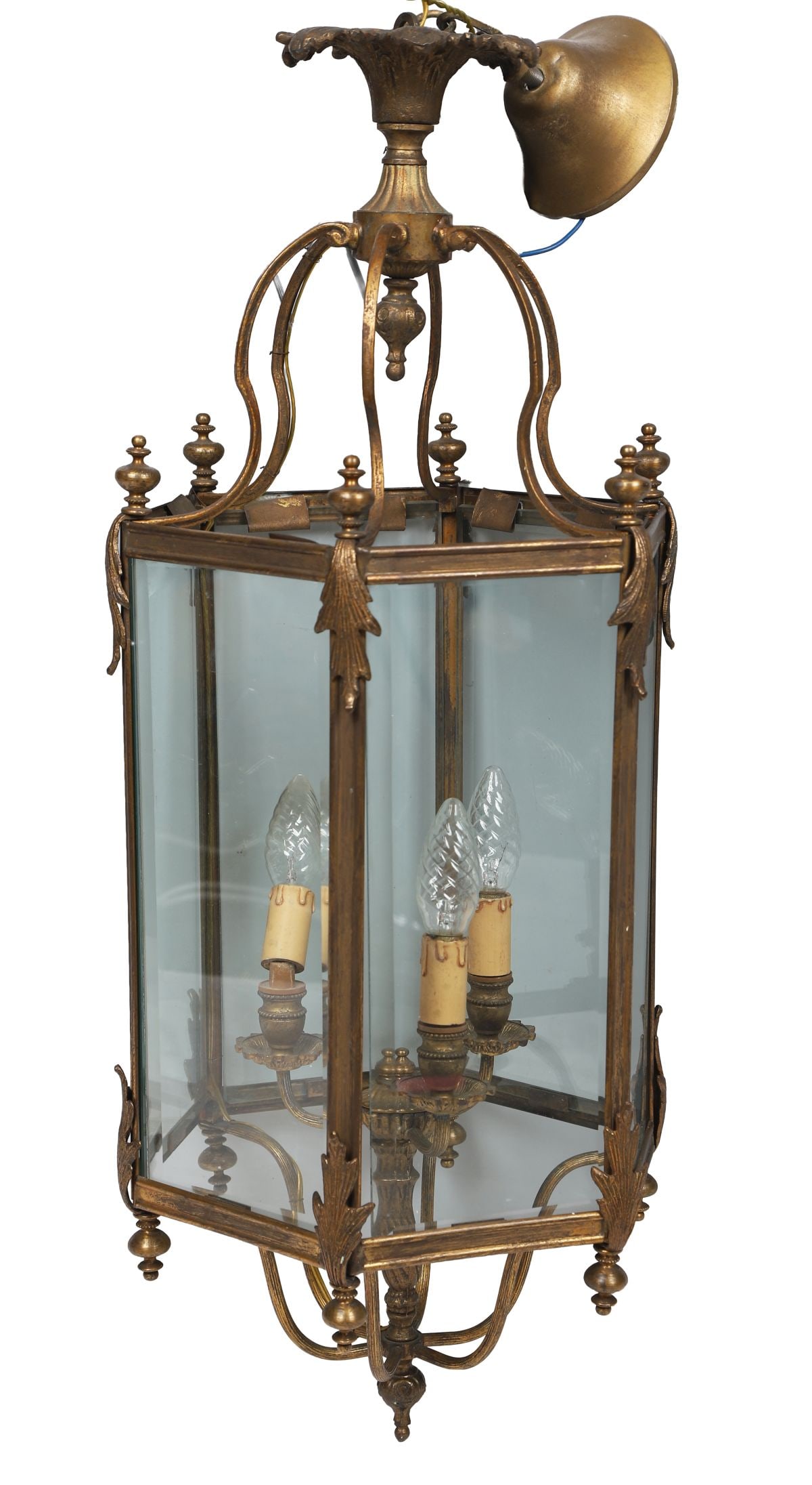 LARGE EDWARDIAN BRASS HALL LANTERN: of hexagonal form suspended on scroll arms emanating from a coronet. The glazed panelled sides enclosing four candle lights. LIGHTING