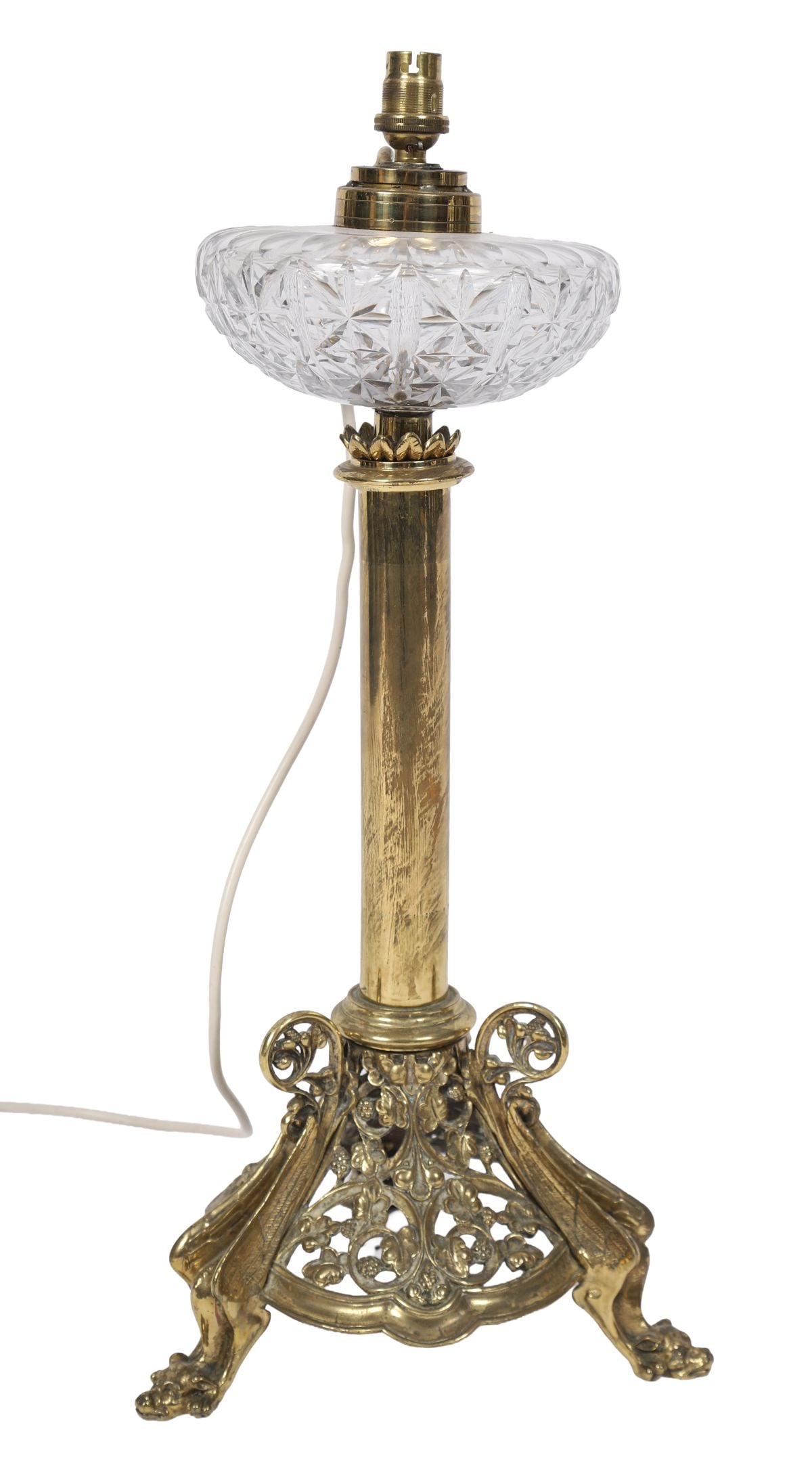 19TH-CENTURY BRASS AND CUT-GLASS OIL LAMP: A 19th-century brass oil lamp, the columnar stem with cast foliate base, fitted with a cut-glass reservoir and later electrical conversion. LIGHTING