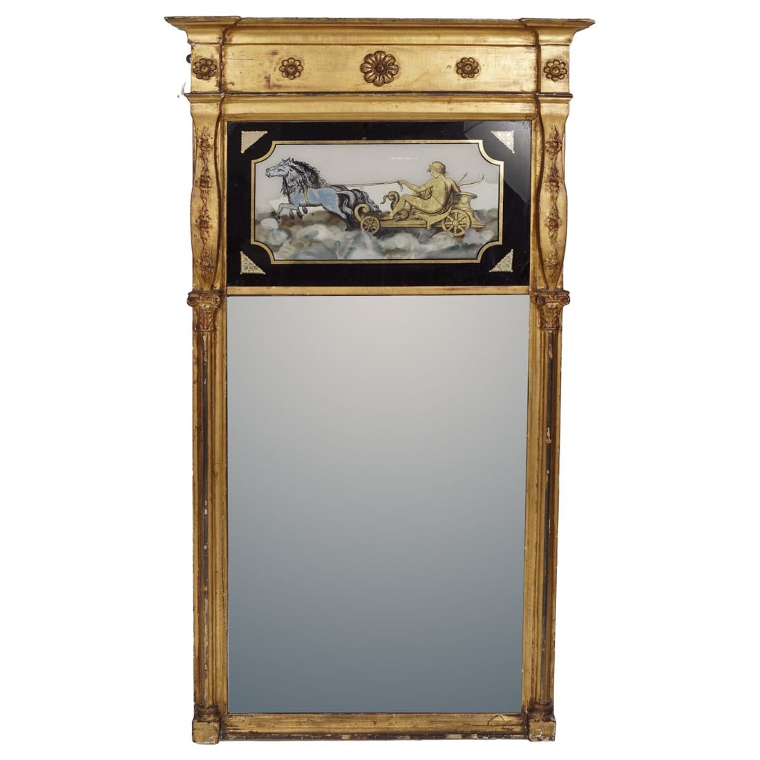REGENCY GILT FRAMED PIER MIRROR: the rectangular plate below a verre églomisé panel depicting a nymph on a horse-drawn chariot, between a Corinthian column on either side, below a paterae frieze and cavetto moulded pediment. MIRROR