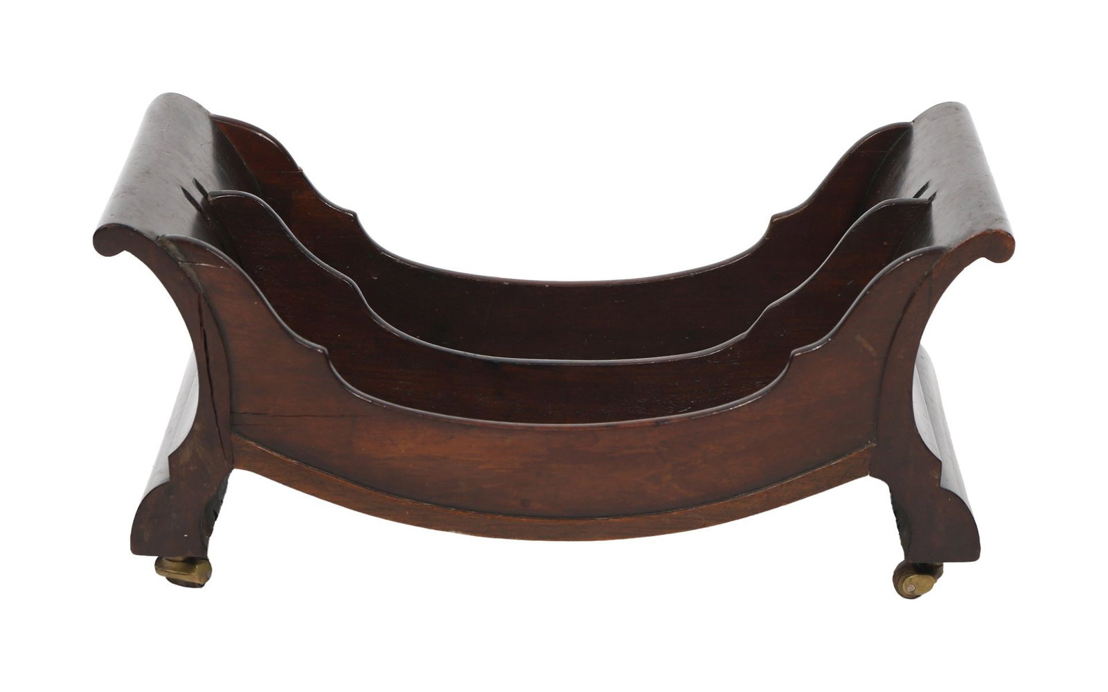 GEORGE III MAHOGANY CHEESE COASTER: Of oval form with turned gallery, fitted with carrying handles and mounted on small brass castors. FURNITURE
