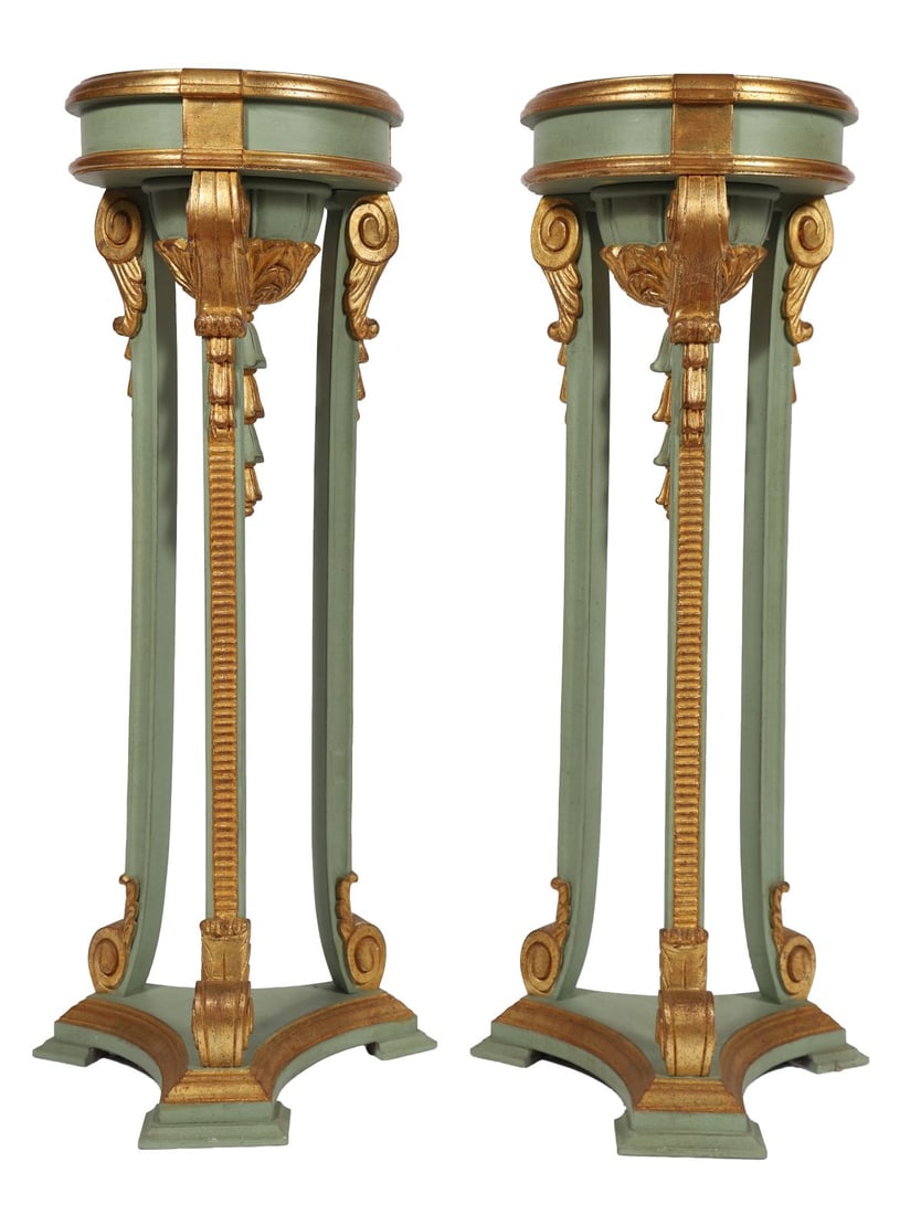 PAIR OF PAINTED AND PARCEL GILT PEDESTALS: Each with circular top above tapering supports with applied gilt decoration and swag ornament, raised on shaped bases. FURNITURE