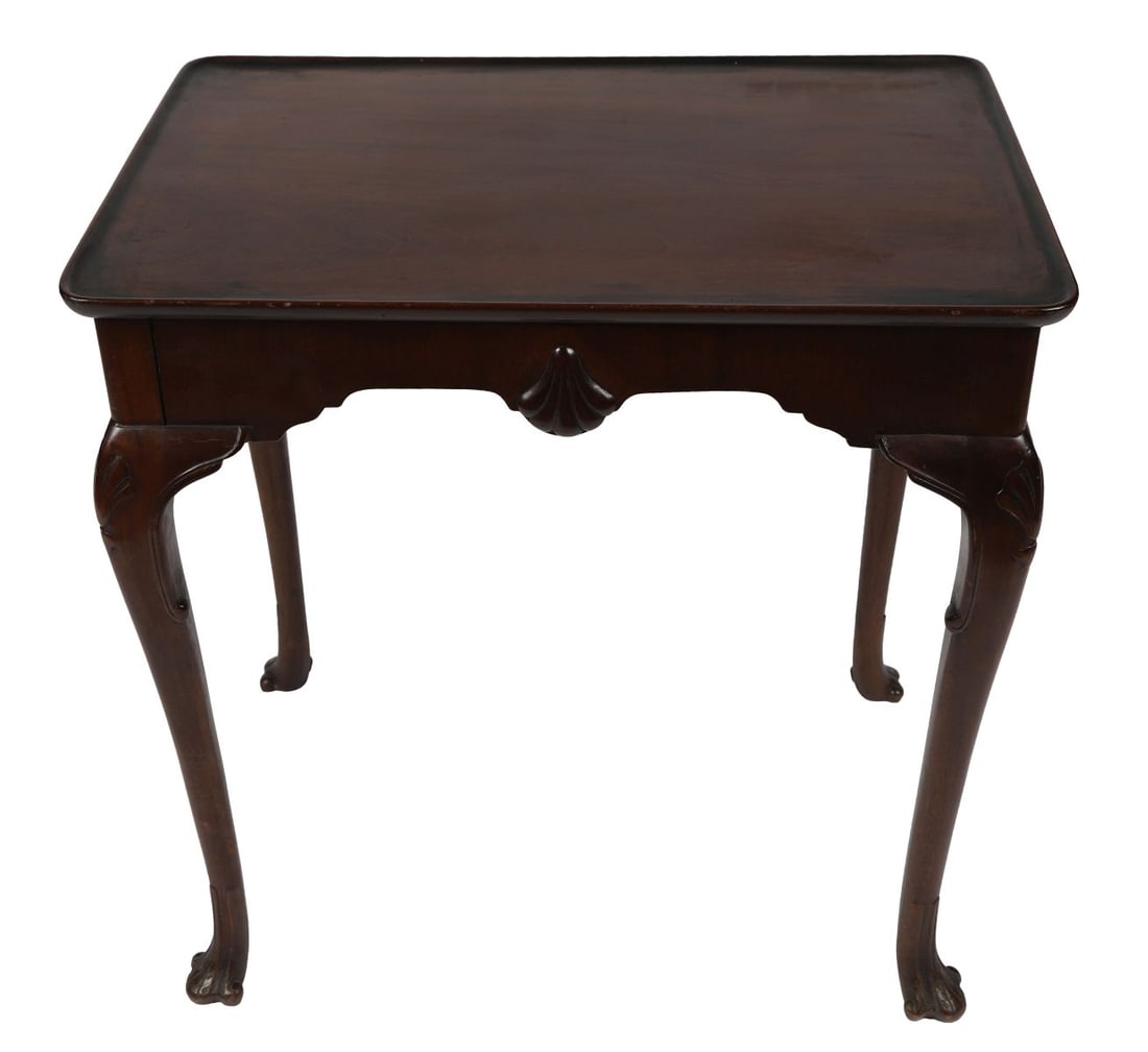 18TH - CENTURY IRISH MAHOGANY SILVER TABLE: The rectangular top above a shaped frieze, raised on carved cabriole legs terminating in pad feet, of good colour and proportion. FURNITURE
