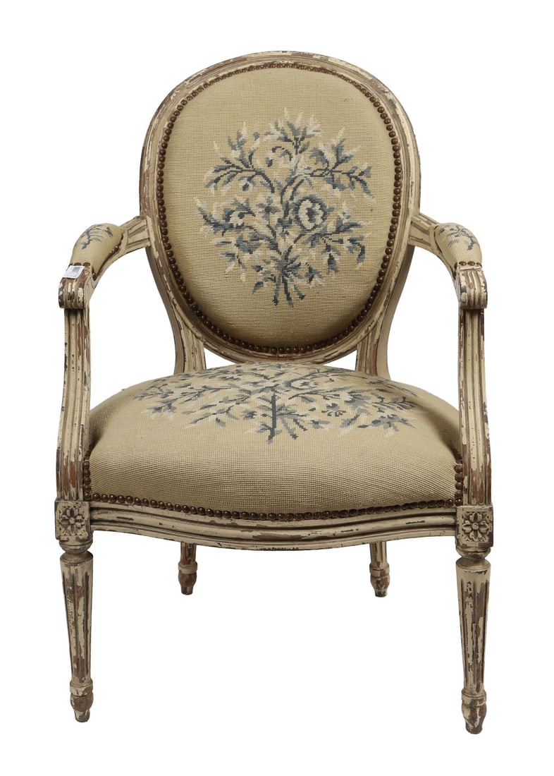PAIR OF LOUIS XVI-STYLE PAINTED ARMCHAIRS: 20TH CENTURY, Oval upholstered backs and seats with floral needlework panels, within moulded painted frames with beaded borders, the shaped arms raised on fluted supports.Condition shows wear to paint