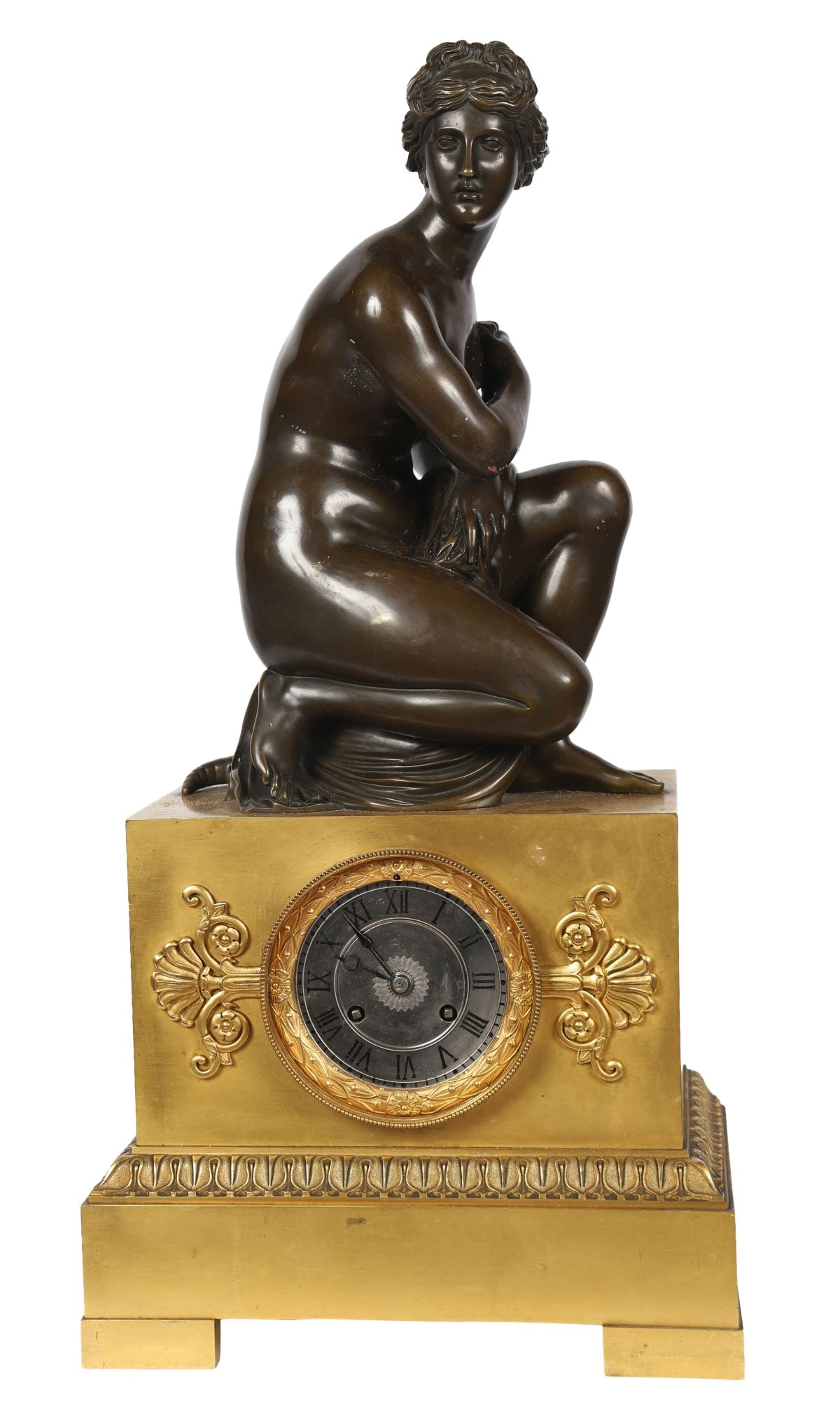 19TH-CENTURY FRENCH ORMOLU MANTEL CLOCK: SURMOUNTED BY A CROUCHING VENUS, A 19th-century French ormolu mantel clock, the case surmounted by a crouching classical female figure, the circular dial within an ornate cast surround, the base decor