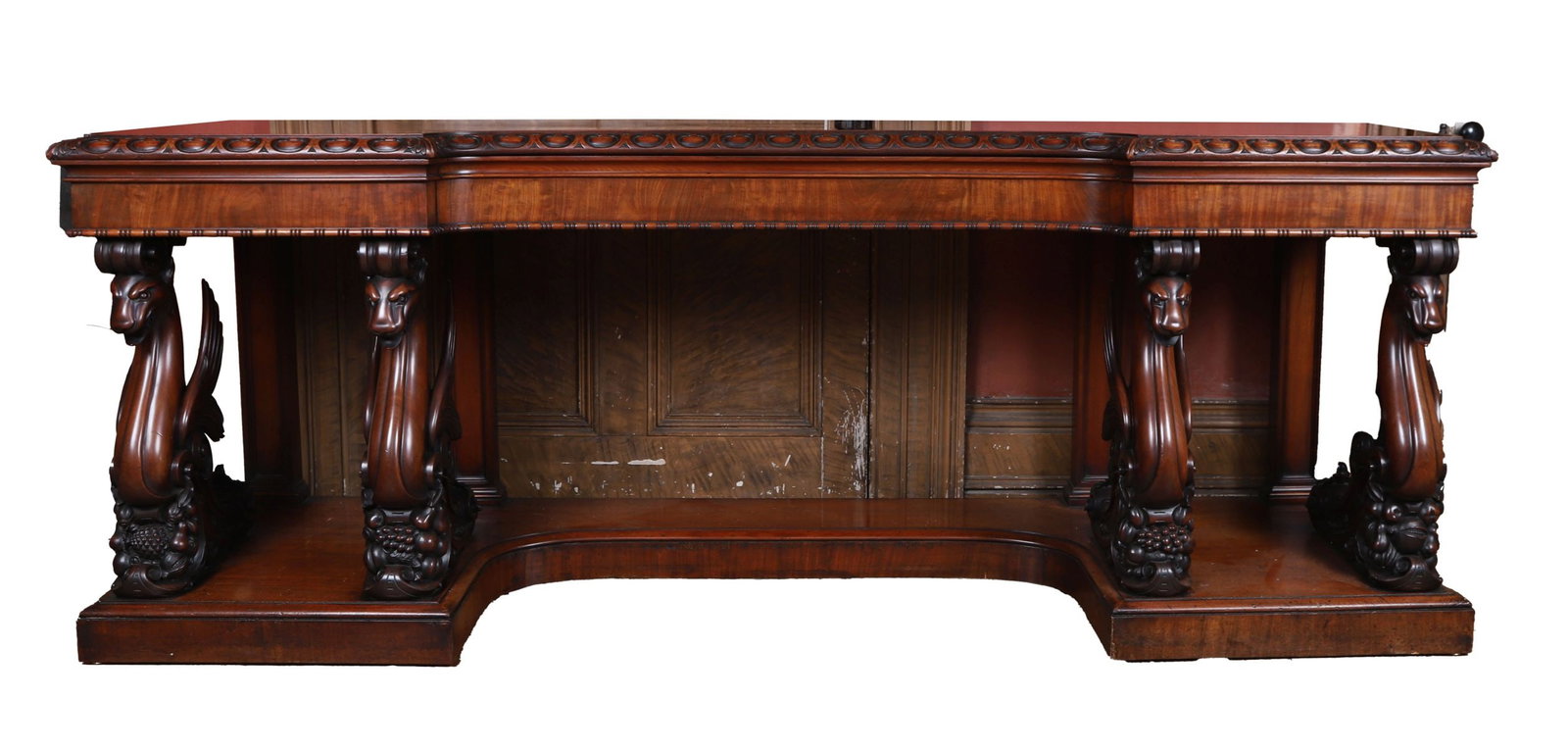 WILLIAM IV PERIOD BREAKFRONT SERVING TABLE: Mahogany, In the Manner of Williams and Gibton, Dublin. The rectangular top above a boldly carved frieze centred by an inverted breakfront, raised on striking supports in the form of winged griffins, 