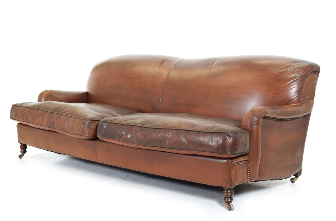 KNOWLE-STYLE COUNTRY HOUSE 3-SEATER SETTEE: With adjustable arms and loose cushions, upholstered in leather. FURNITURE