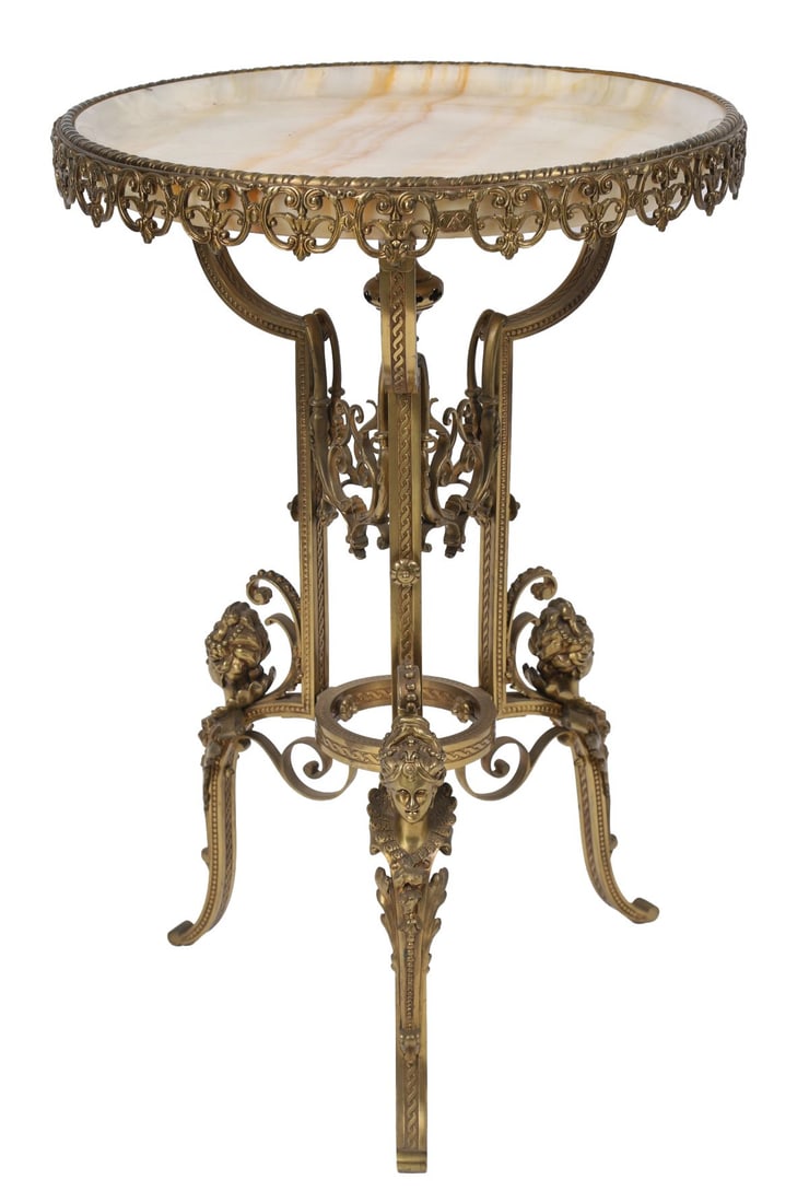 FRENCH ONYX AND GILT-METAL OCCASIONAL TABLE: EARLY 20TH - CENTURY, The oval onyx top within a pierced gilt-metal gallery, raised on scrolling supports joined by a stretcher and terminating in paw feet. FURNITURE