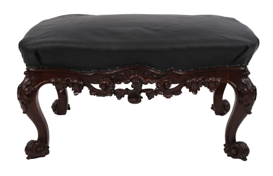 19TH-CENTURY CARVED MAHOGANY STOOL: A 19th-century mahogany stool, the upholstered seat raised on cabriole legs with carved foliate ornament and shaped apron. FURNITURE