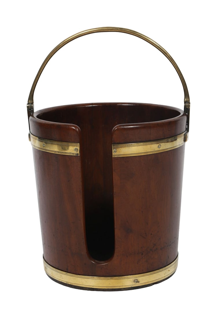 GEORGE III MAHOGANY AND BRASS-BOUND PEAT BUCKET: Of cylindrical form with brass mounts and carrying handle. FURNITURE