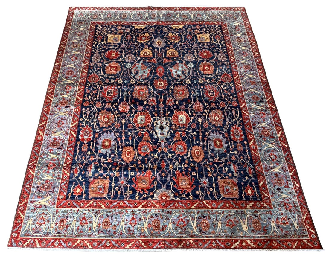 20TH - CENTURY PERSIAN TABRIZ CARPET: (TABATABAEI DESIGN) The deep navy field with an all-over lattice of scrolling vines, palmettes, and stylised animal and vase motifs, in the Tabatabaei manner, enclosed within a light blue and red flor