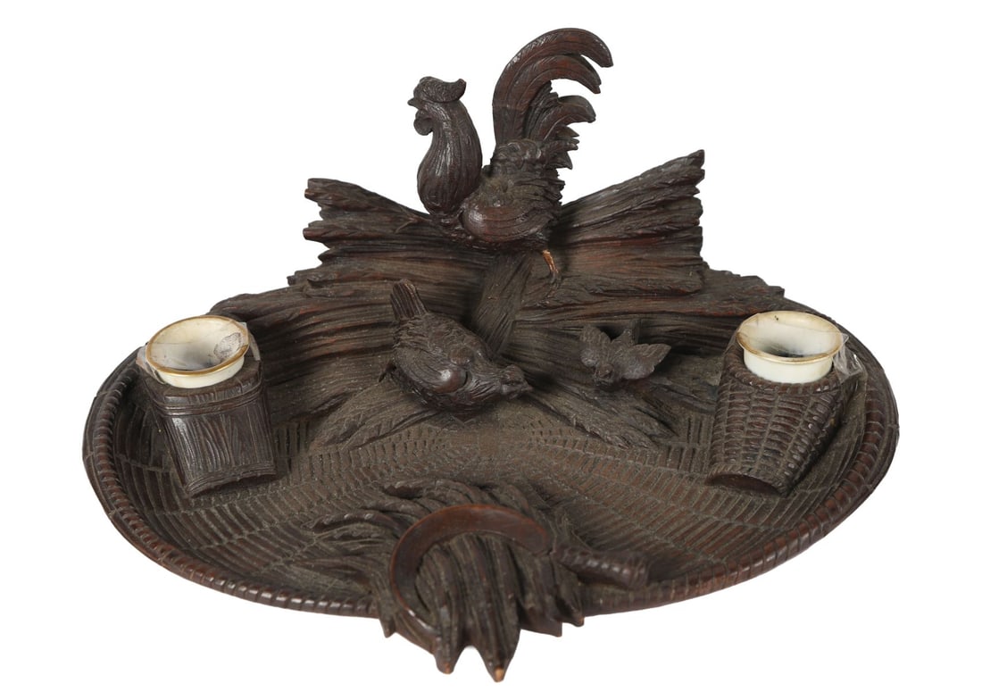 BLACK FOREST CARVED WOOD PEN & INK STAND: OF BIRDS IN A CORNFIELD. A 19th-century Black Forest carved wood group pen and ink stand depicting birds amongst sheaves of corn, naturalistically rendered with textured ground and foliage, incorporat
