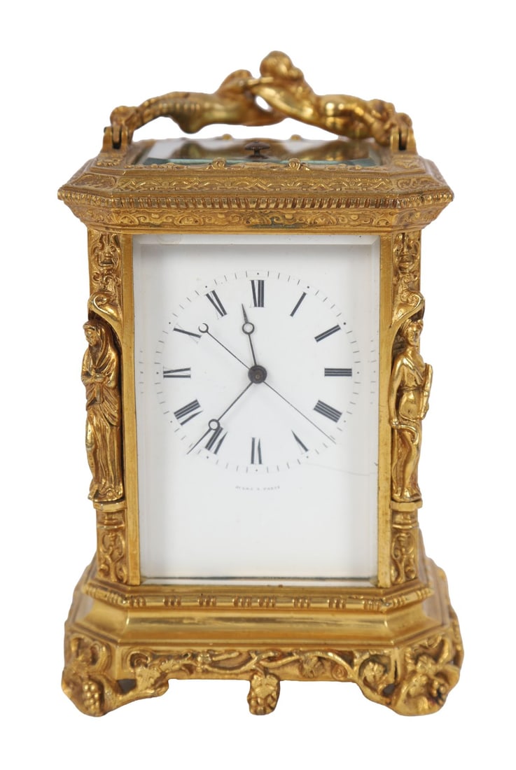 FRENCH GILT-BRONZE REPEATING CARRIAGE CLOCK: 19TH-CENTURY, Gilt-bronze cased carriage clock with glazed panels, the white enamel dial with Roman numerals, the case cast with classical figures to the corners and surmounted by a shaped handle with