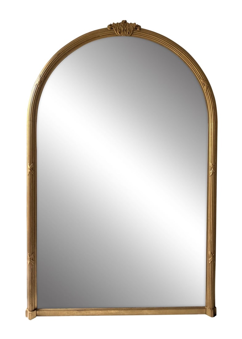 LATE 19TH-CENTURY GILT-FRAMED OVERMANTEL MIRROR: Of tall arched rectangular form, the frame with reeded moulding and applied decorative motifs, finished in gilt, enclosing a single mirror plate. MIRRORS