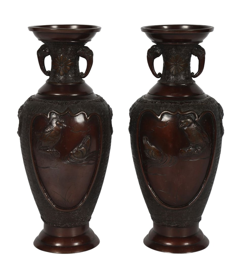 PAIR OF JAPANESE BRONZE VASES: Each of baluster form with twin handles, cast in relief with birds and foliage within shaped reserves, the ground with textured decoration. JAPANESE
